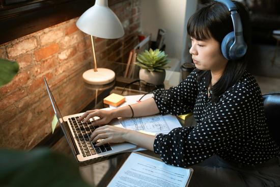 Person at desk researching career guide for people with disabilities on laptop.